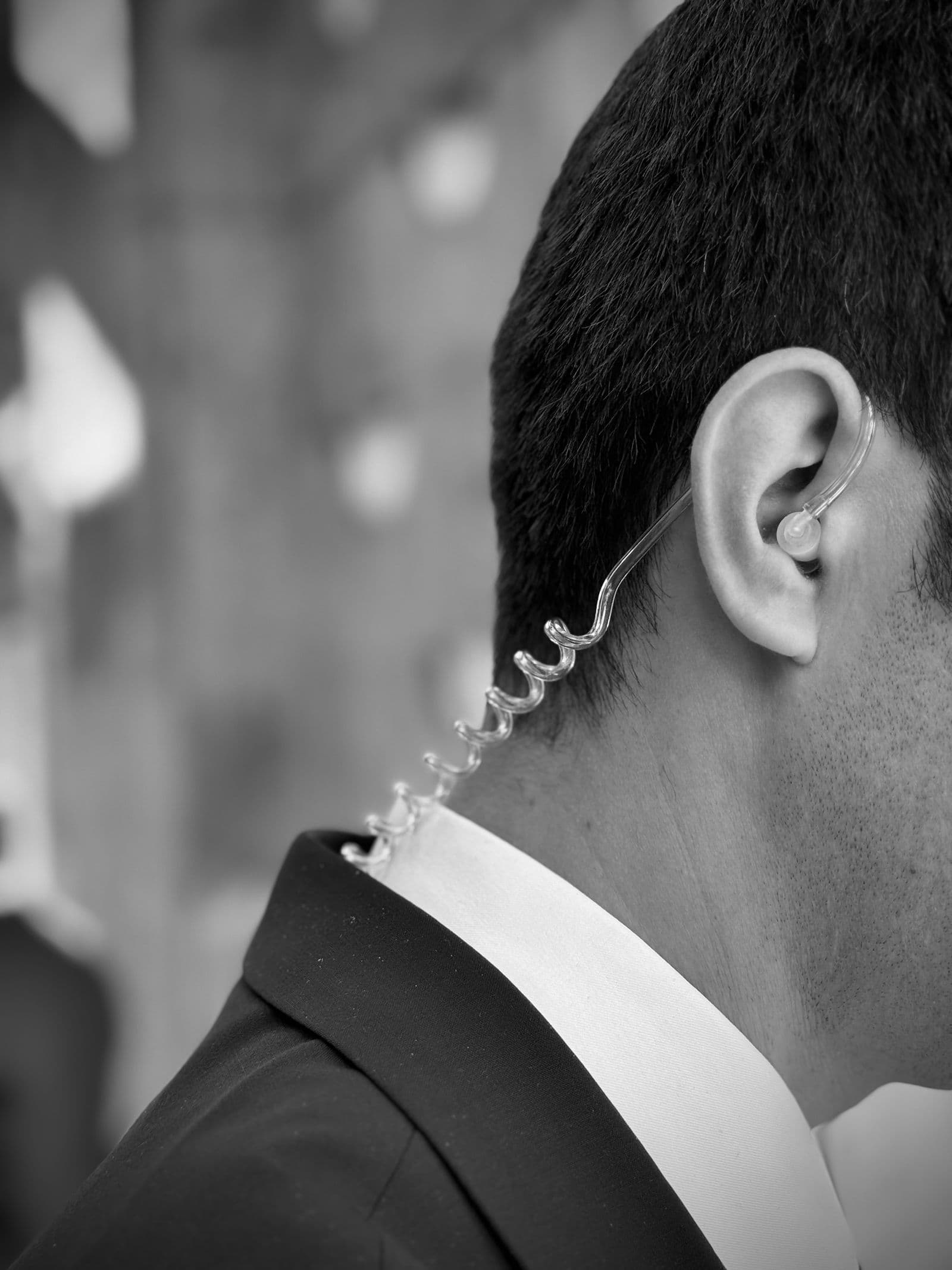 Close protection professional wearing a discreet earpiece