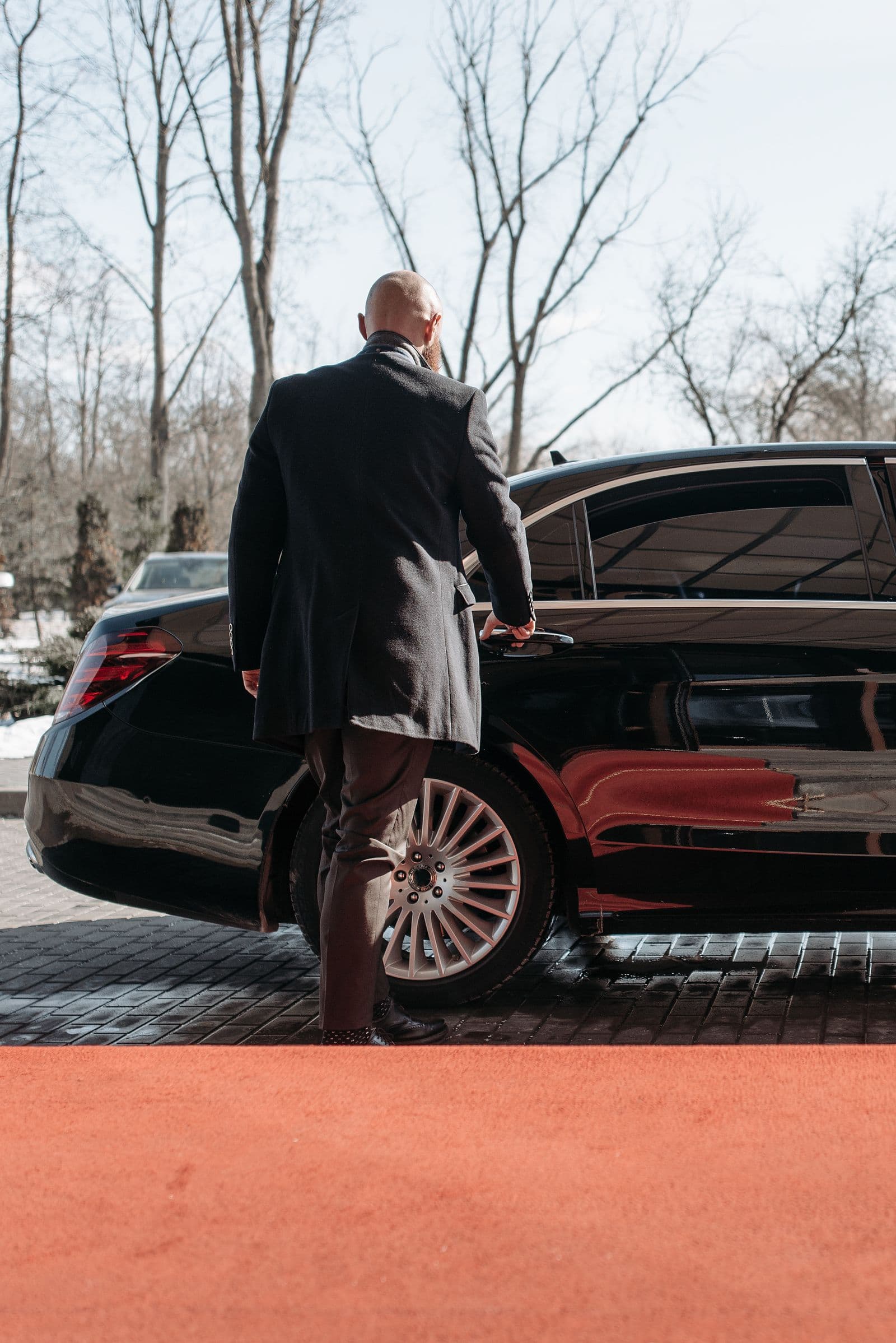 Executive car waiting at a private entrance