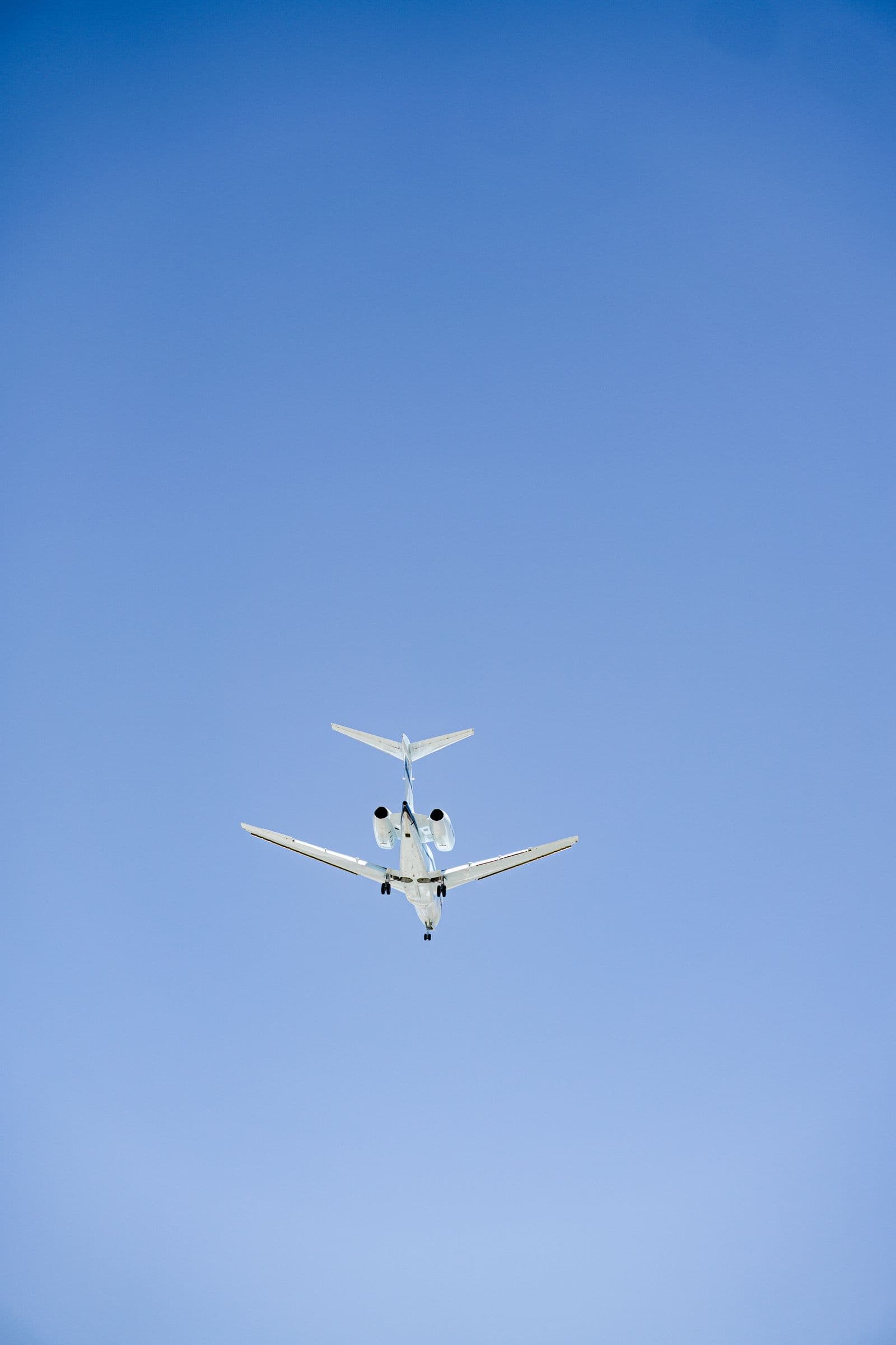Private jet climbing into a clear blue sky
